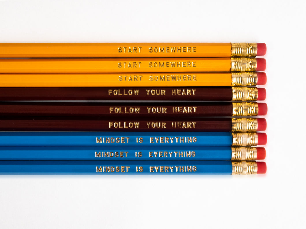 Set of 9 foil engraved pencils in the colors yellow, dark red, and bright blue. Each pencil has a unique quote on the pencil, 