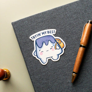 A cute mini Mt Fuji mountain smiling with a tear drop near his eye. MT fujii is wearing a backpack and the text says Tryin' My Best