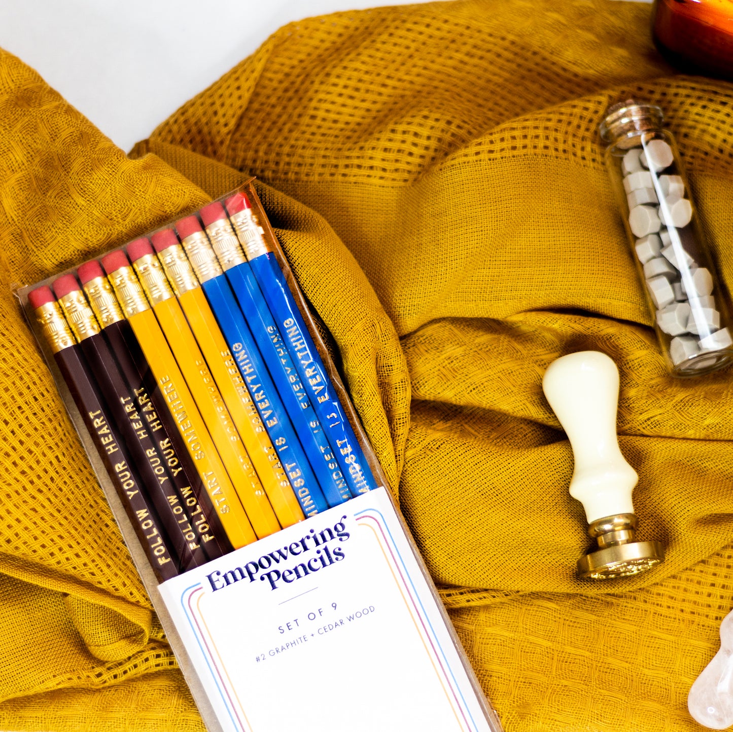 Set of 9 foil engraved pencils in the colors yellow, dark red, and bright blue. Each pencil has a unique quote on the pencil, "Start Somewhere" "Follow Your Heart" "Mindset is Everything"